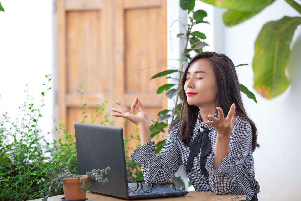 smiling businesswoman shows gestures meditate